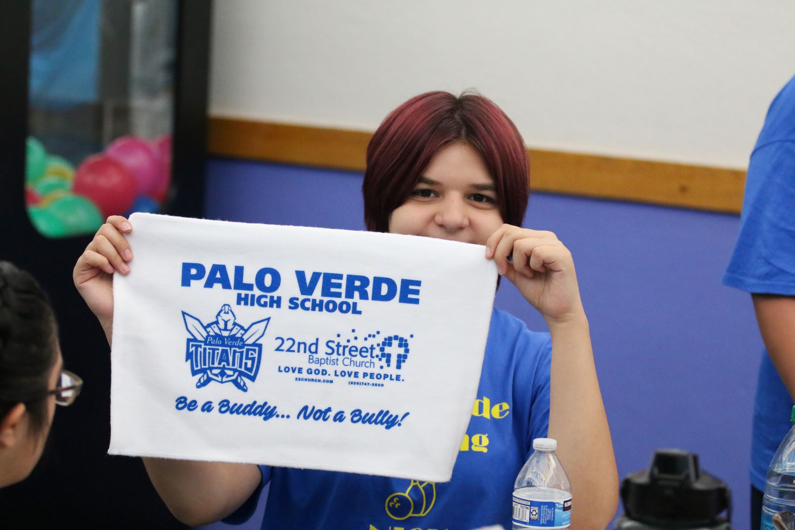 Student holding sign for PaloVerde Be a Buddy not a Bully