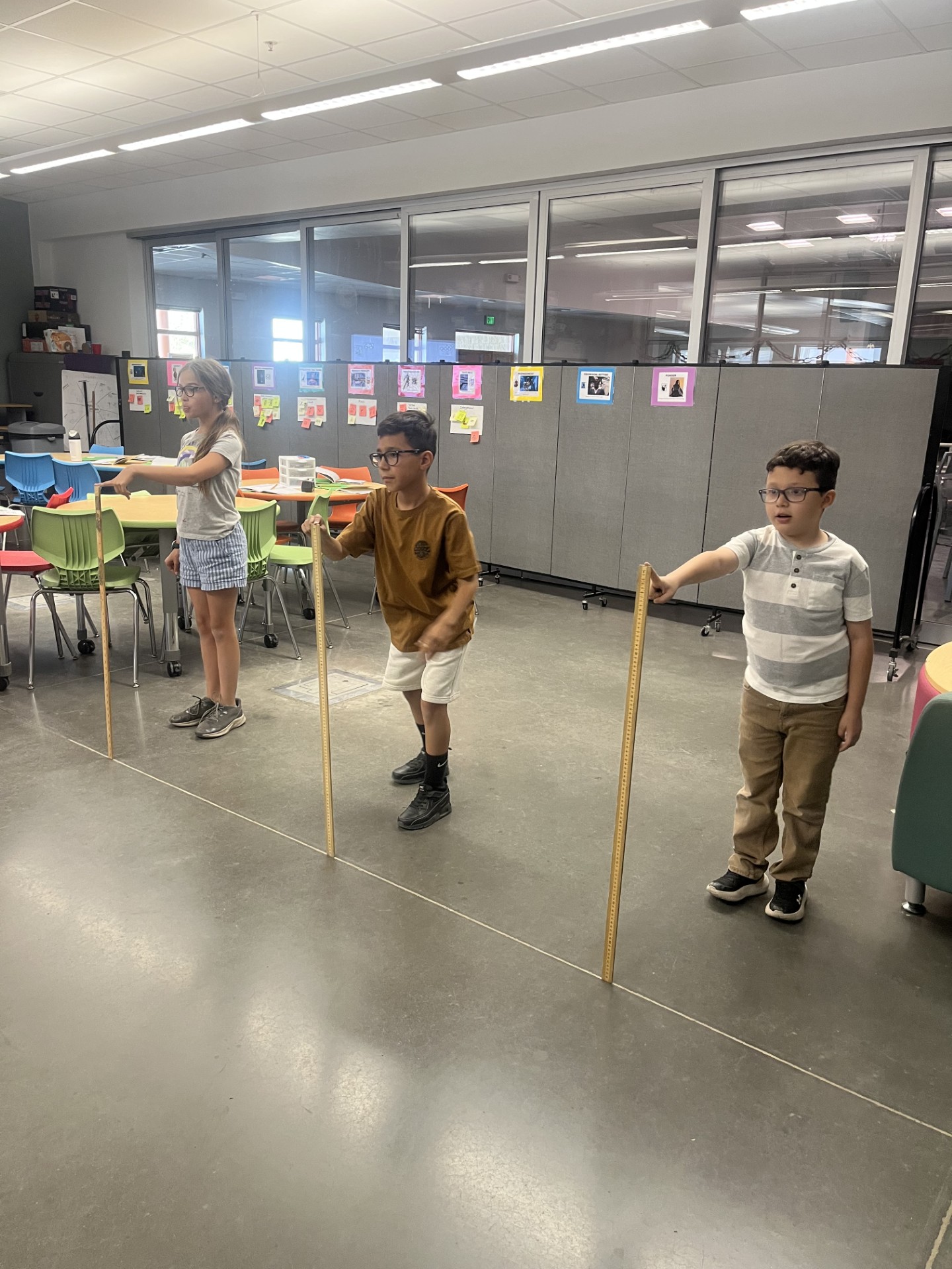 Students lined up to participate in a race where they let go of a meter stick and their team mates run to catch it before it falls.