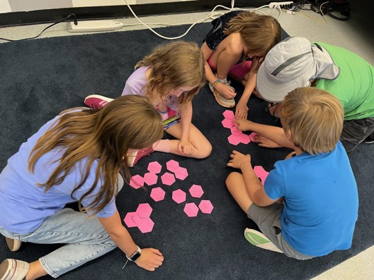 Fourth-grade students at Hughes Elementary working together to organize their ideas about power using hexagonal thinking.