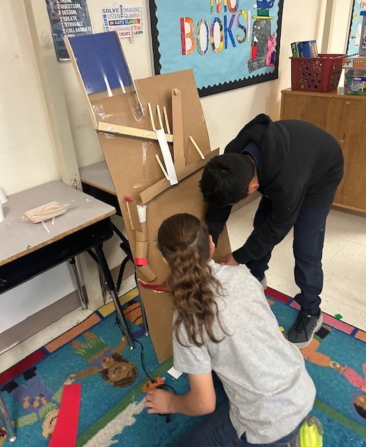 Picture of students engineering Rube Goldberg Machines