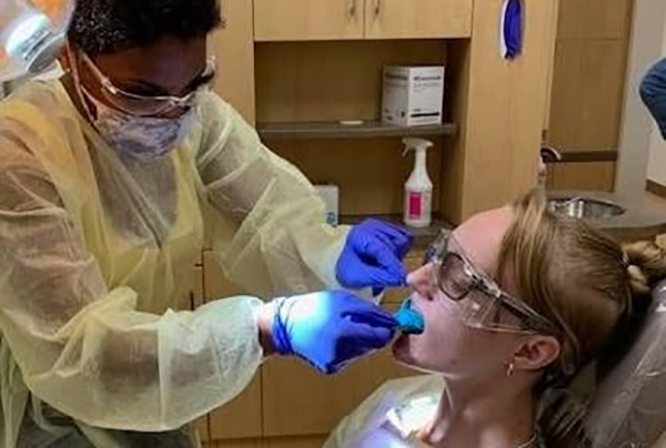 Dental student working on a patient