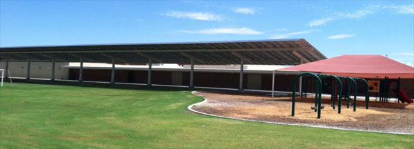 Solar panels provide shade cover in play areas.