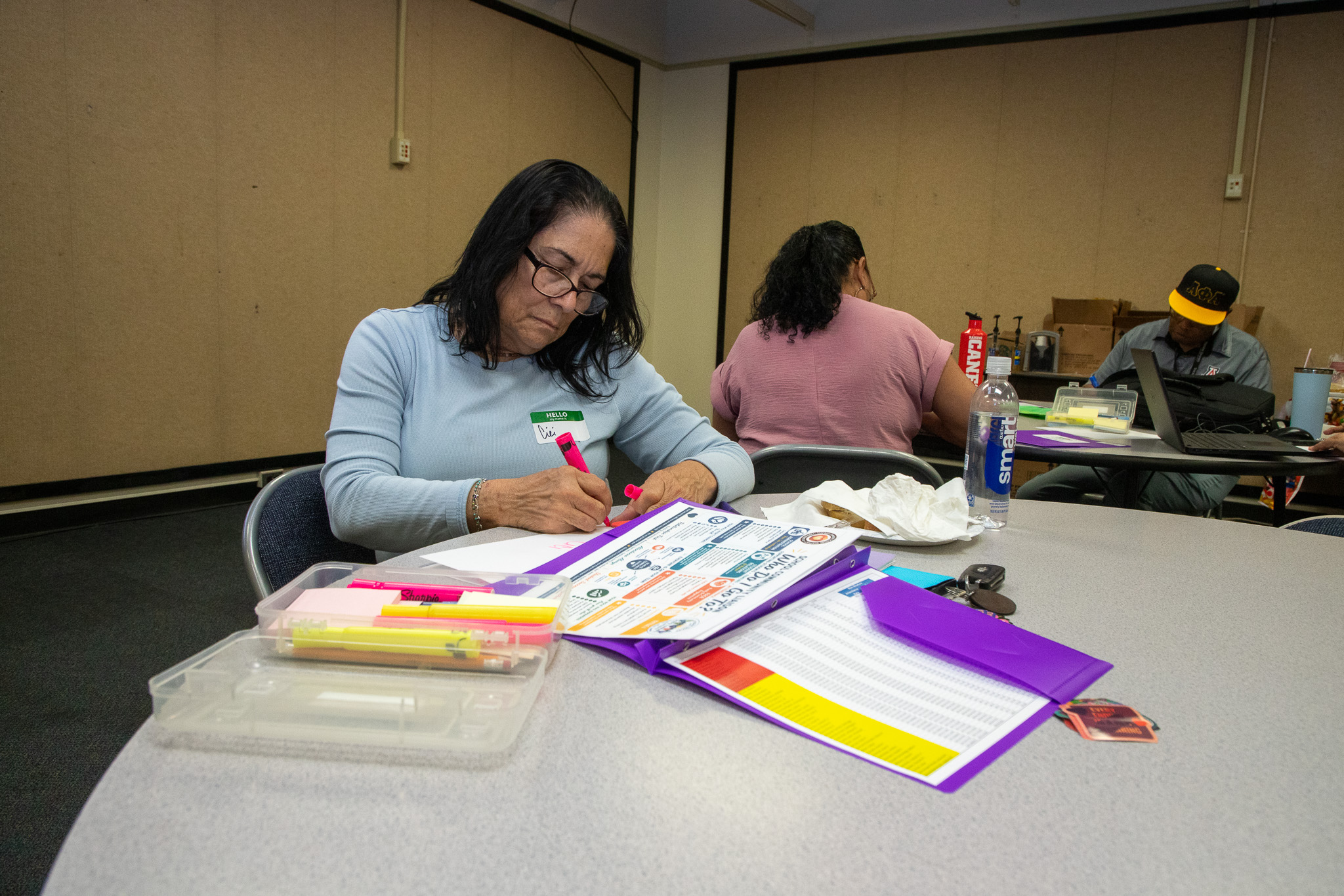 A woman highlights things on a piece of paper