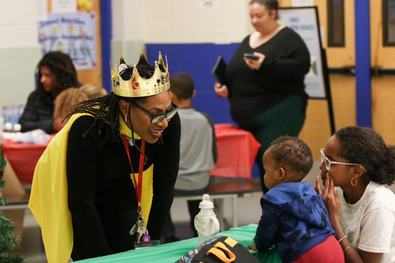 AASSD Director Tonya Strozier talks with a young boy and his mom.