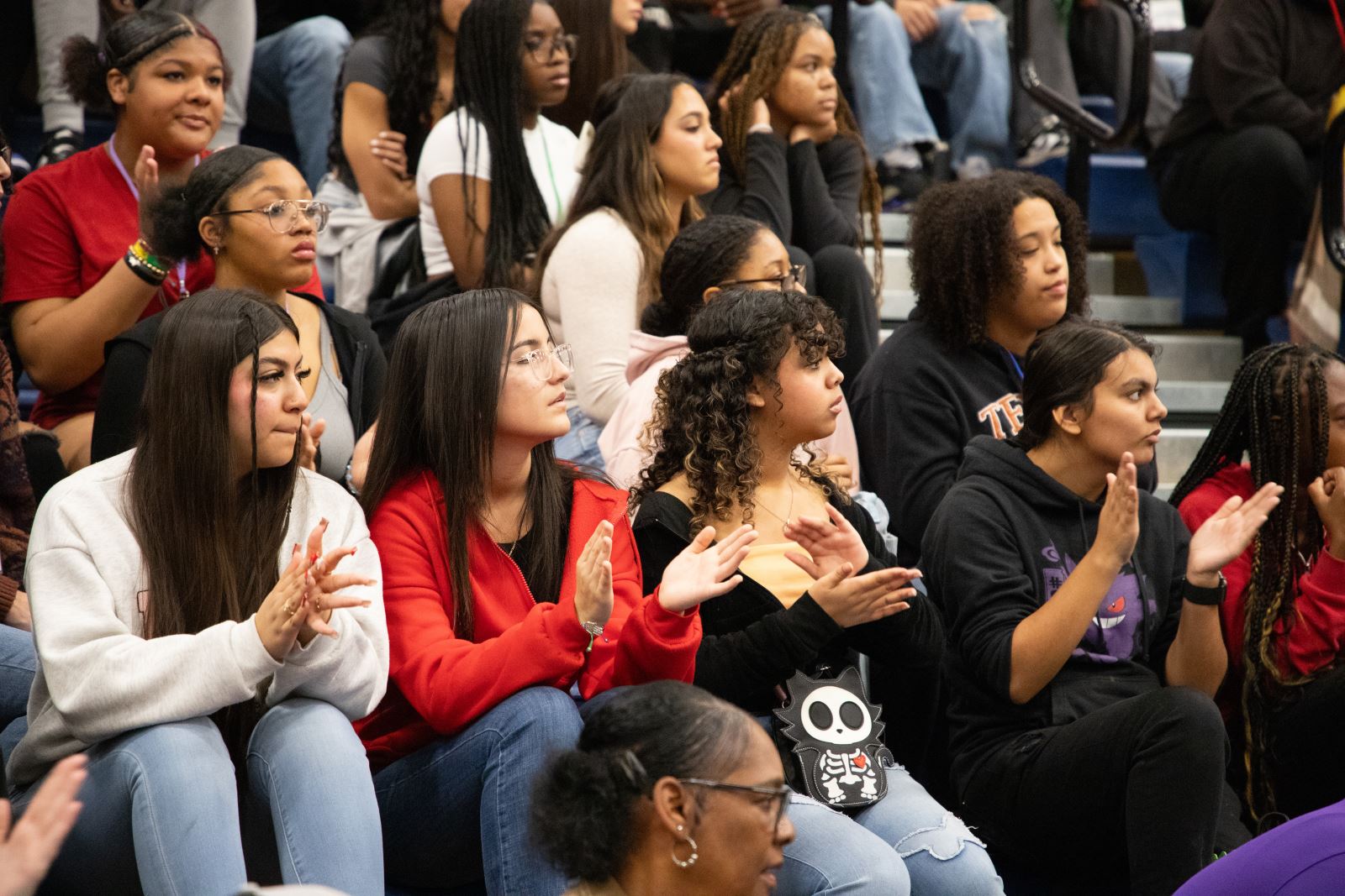 Students in the audience clap.