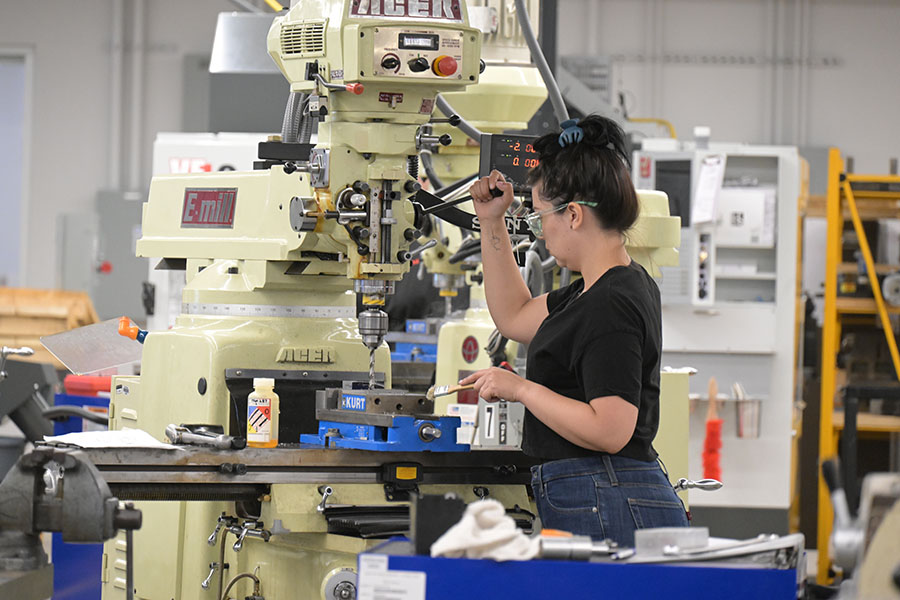 A woman works on machinery