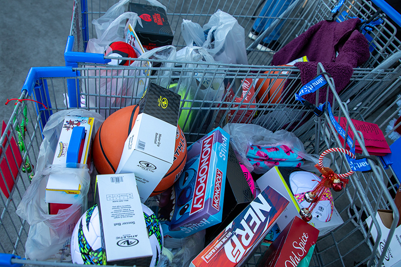 Two shopping carts filled with toys and other gifts