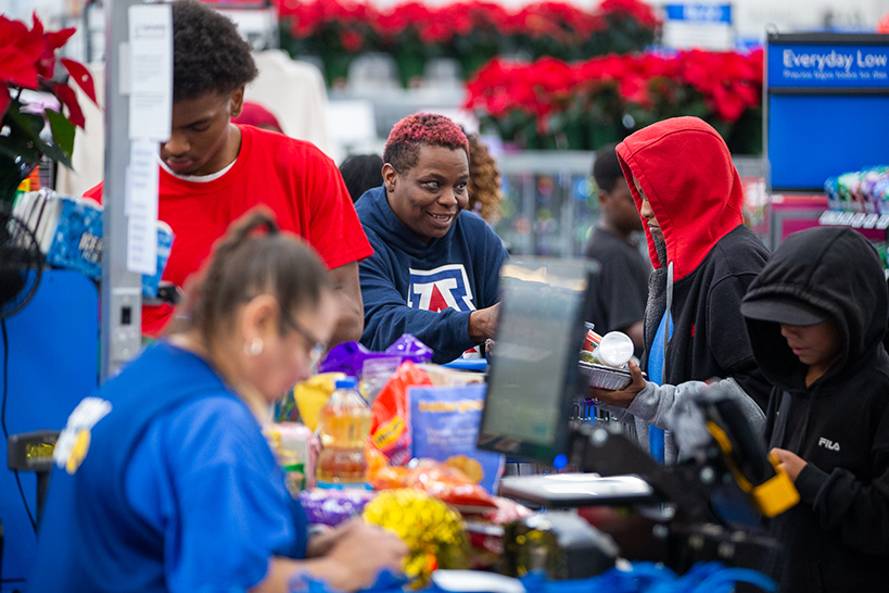 A group of teens in a grocery checkout line