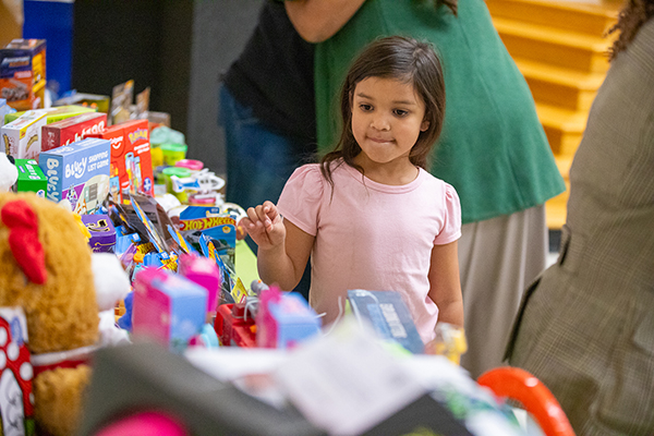 A little girl checks out the prize table