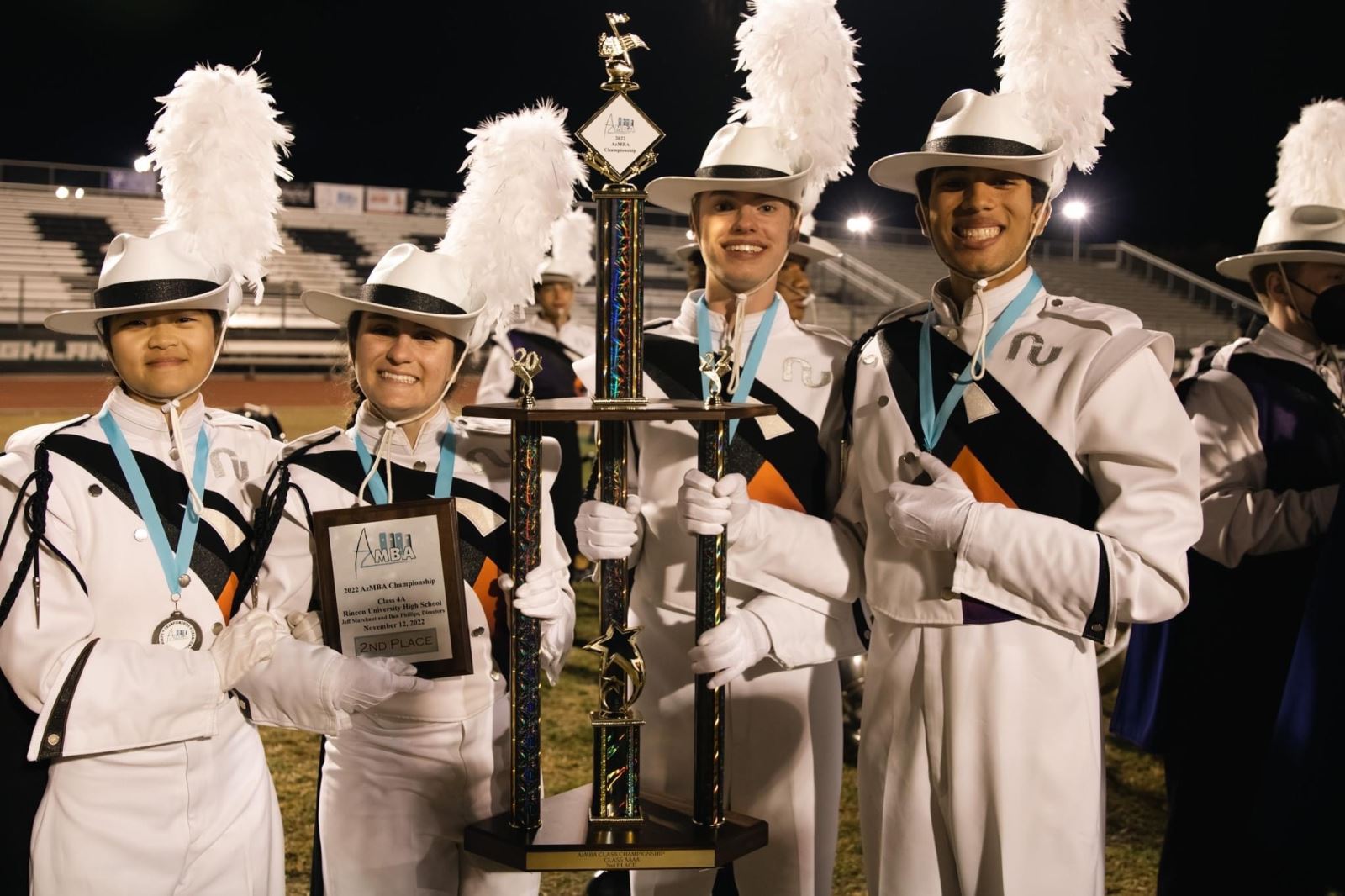 Students hold second place trophy and plaque.