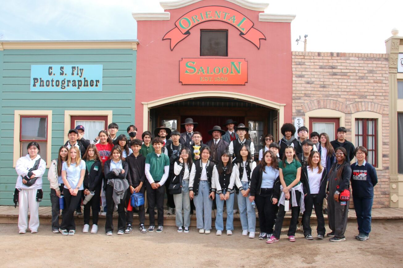 Group photo of TKAP students and Tombstone reenactors in front of the saloon
