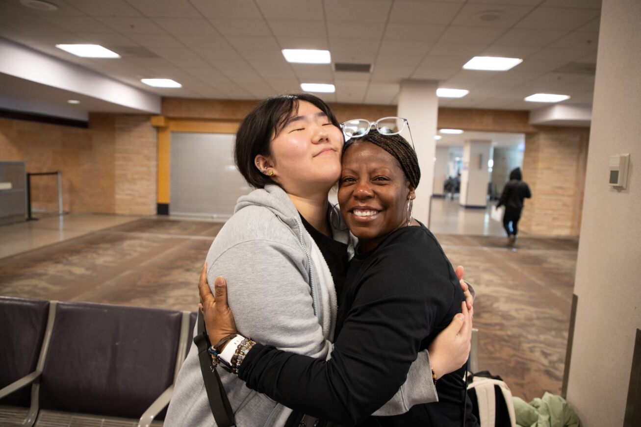 A Korean student hugs her host mom