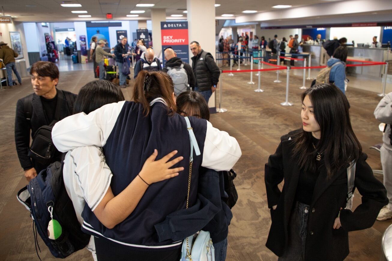 A group of Korean students hug each other