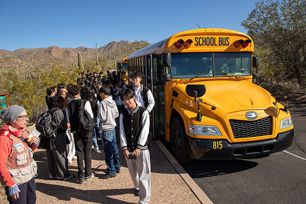 Students file off the school bus