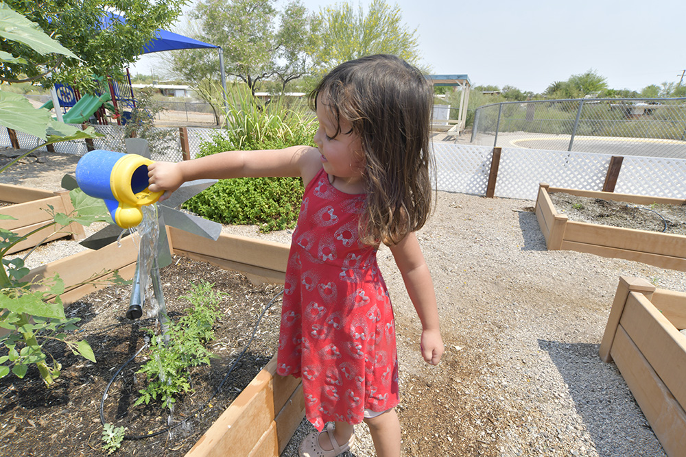 Child watering garden