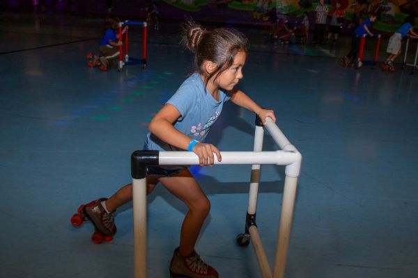 A little girl rollerskates