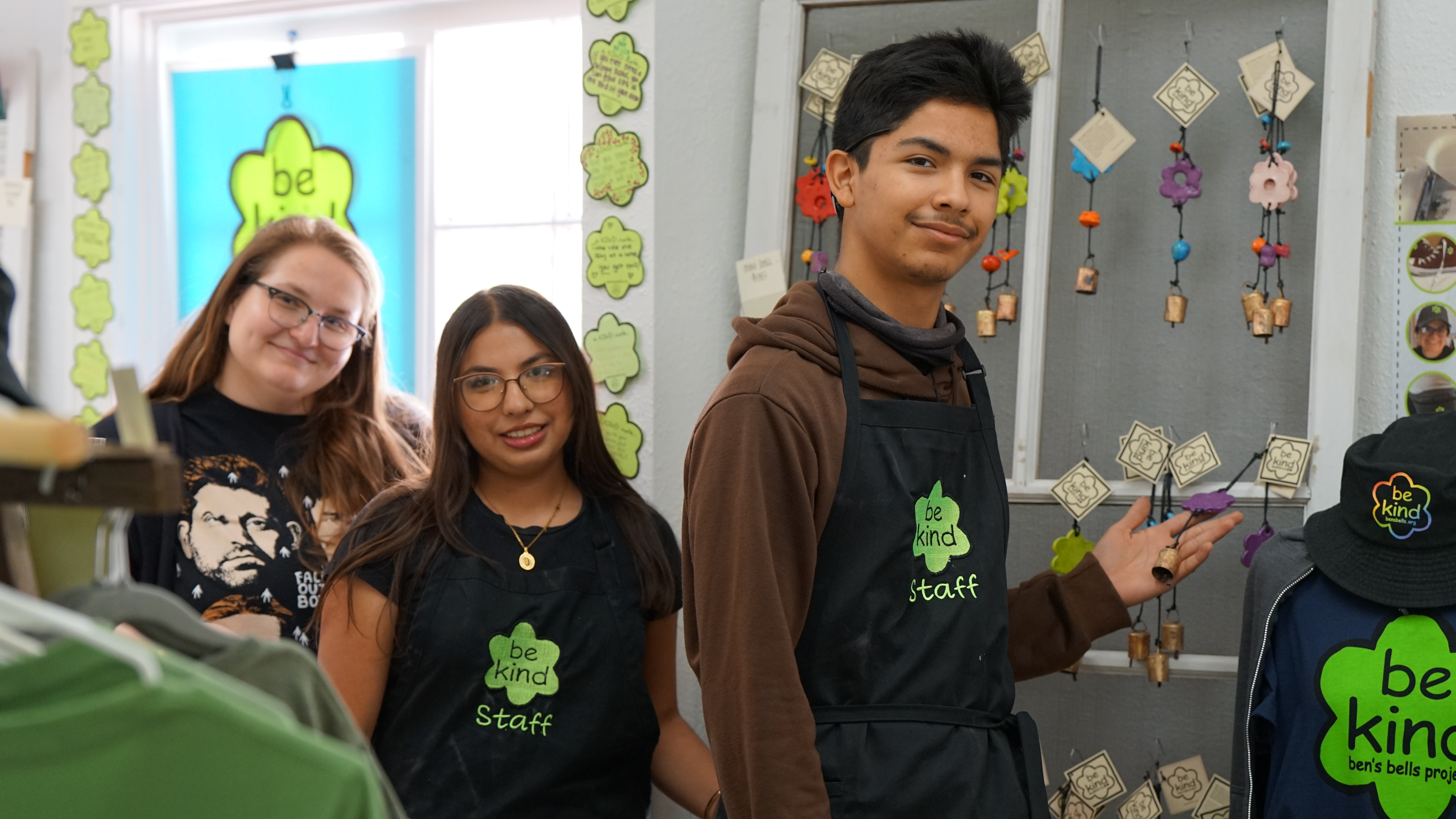 Three students show off the Be Kind items they've created 
