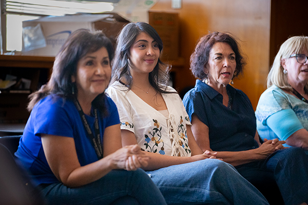 Four women sit in a row