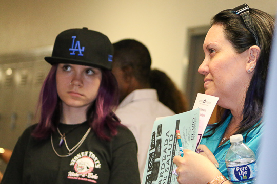 Child and adult listen intently.