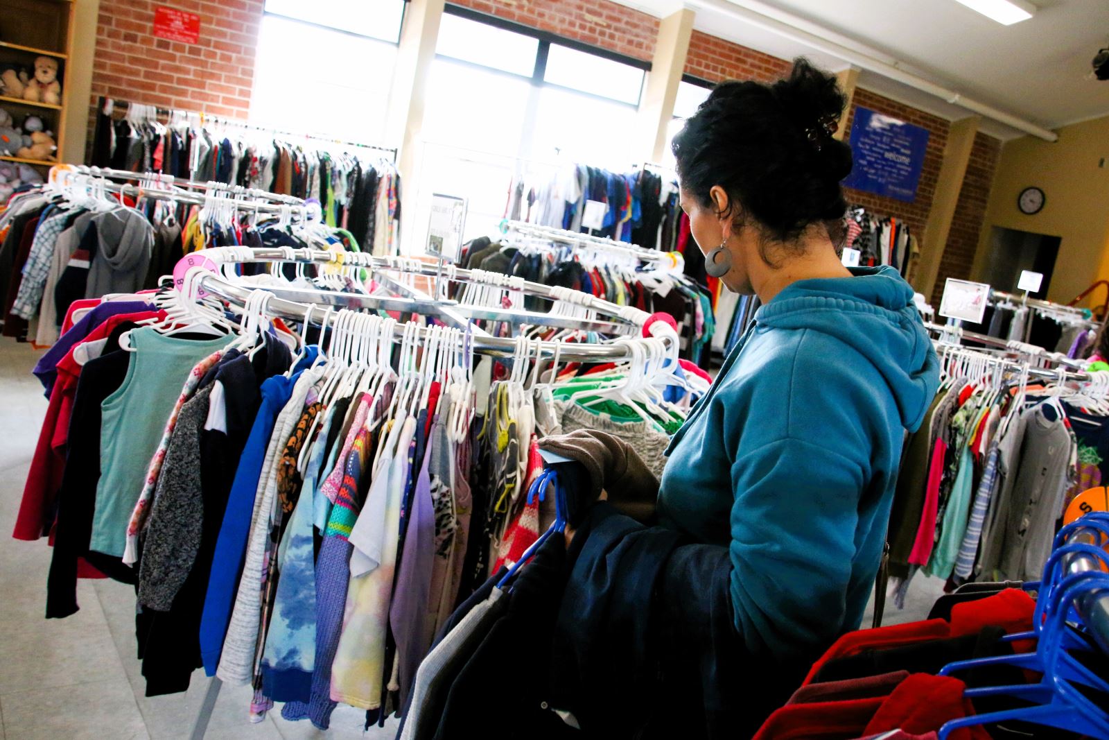 A woman browses the clothing racks at the Duffy Clothing Bank.