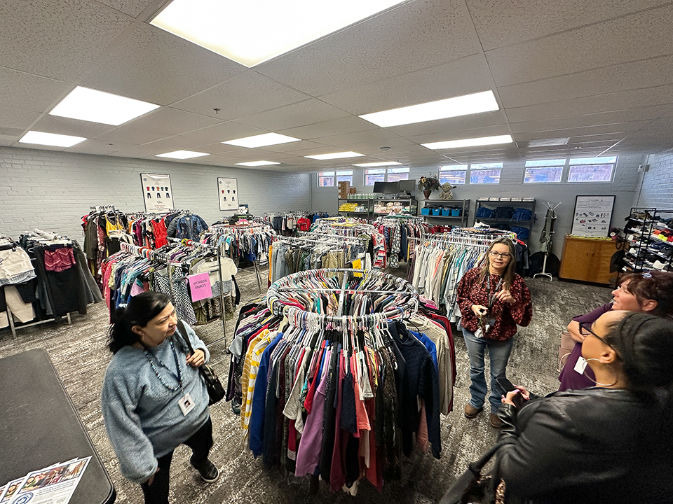 People browse the clothing racks at the FRC