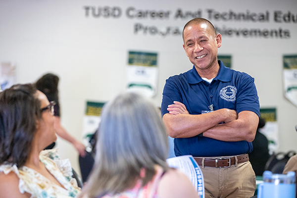 Dr. Trujillo talks animatedly with two women 