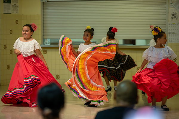 Little girls twirl in their colorful folklorico dresses