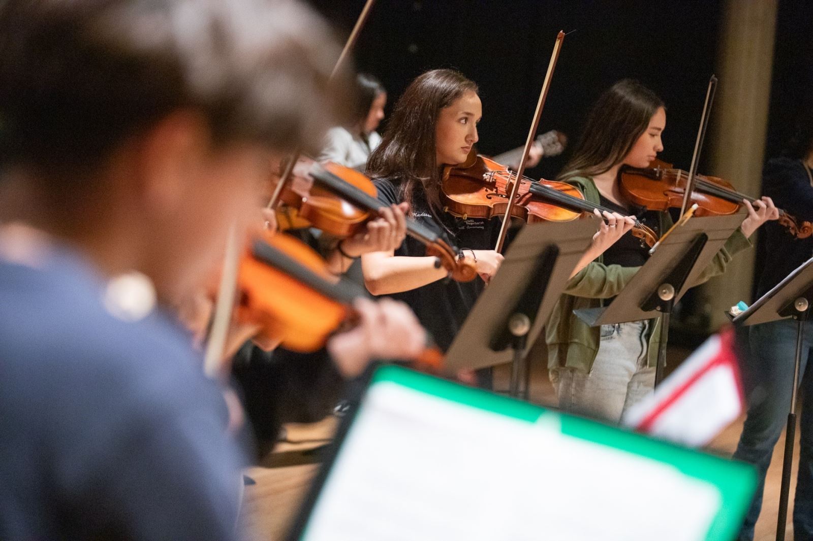 Mariachi students practice on their violins