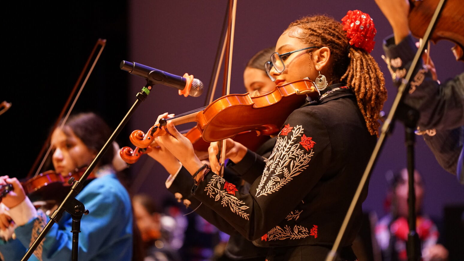 Mariachi students perform on the violin