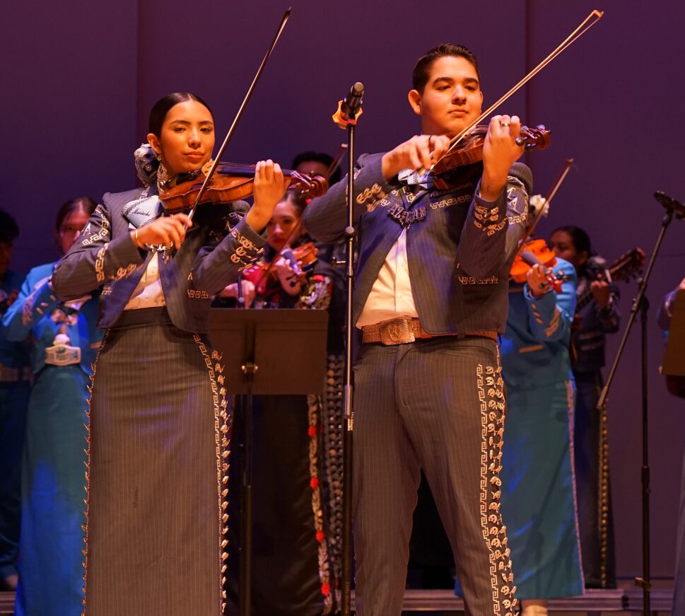 Two students perform on the violin