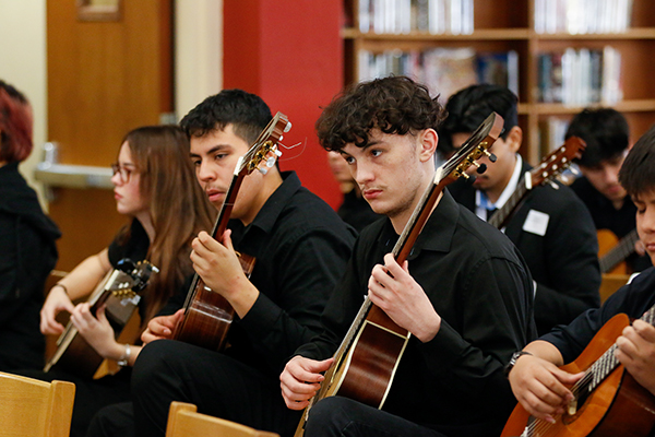 High school students play guitar