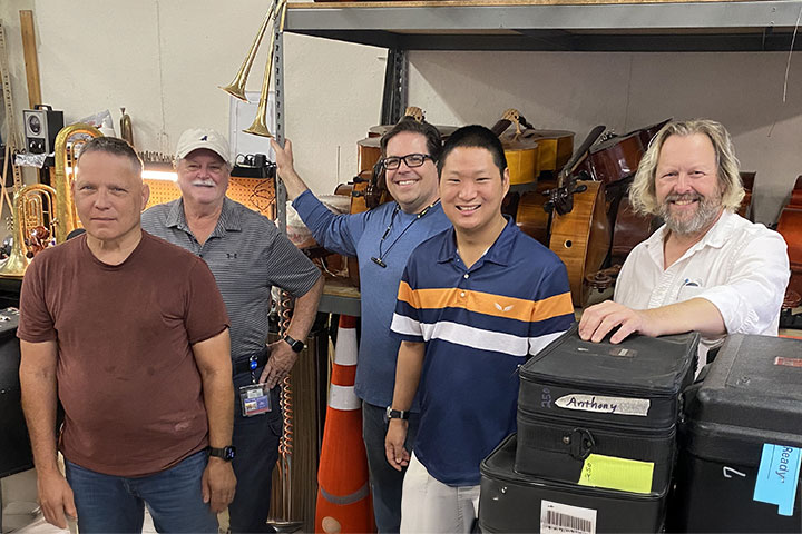 The repair shop crew posing inside the workshop.