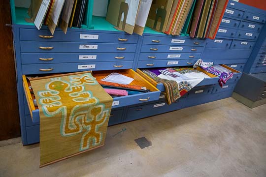 Numerous art objects are stored in flat cases.