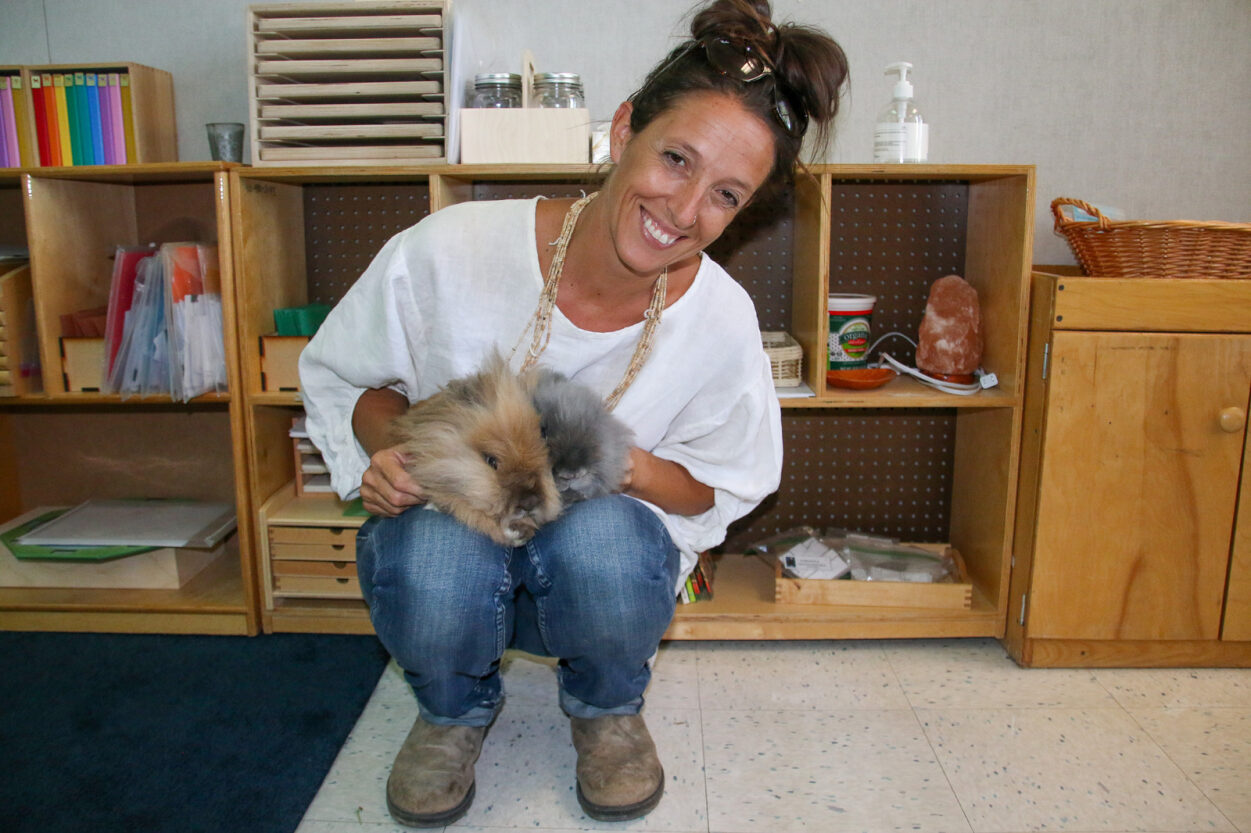 Parent volunteer Sandy McPadden holds the two bunnies.