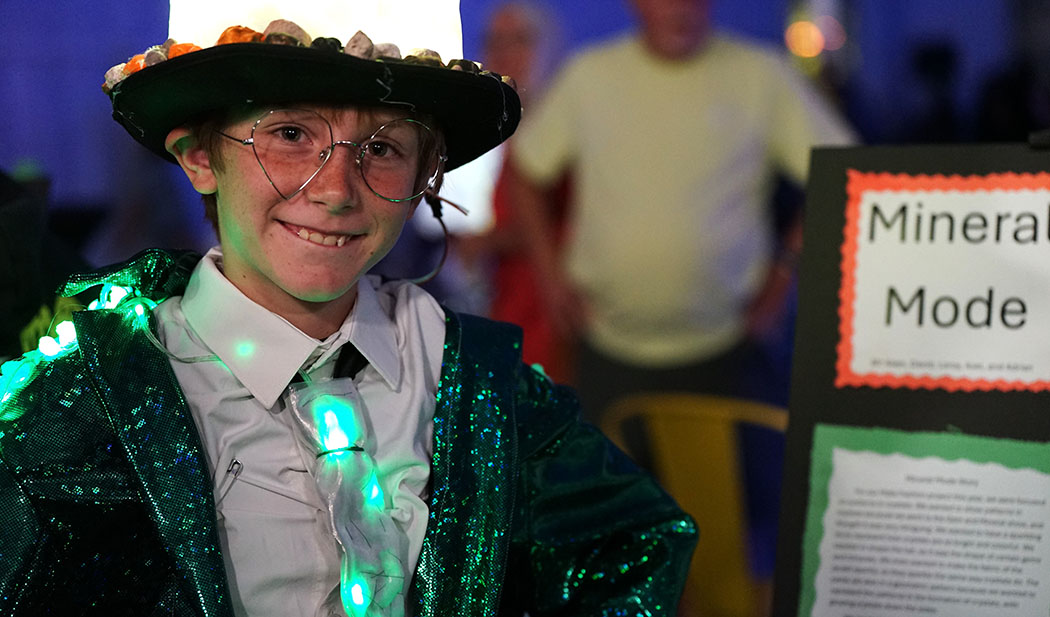 A boy shows off his light up tie