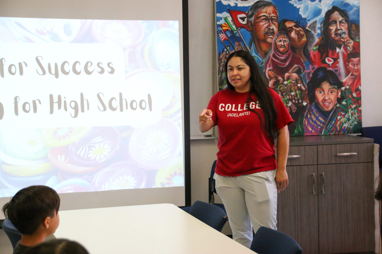 A woman leads a seminar at ¡Adelante! for high school students.