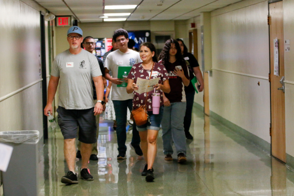 A family walks in a hallway