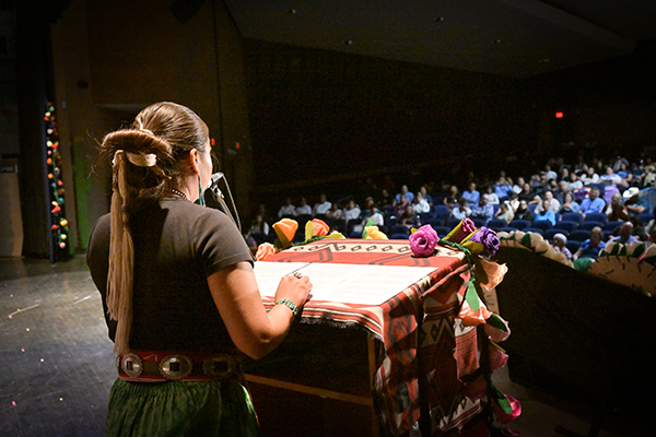 A woman addresses the audience at the ceremony