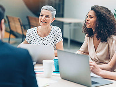 Two women smiling in meeting