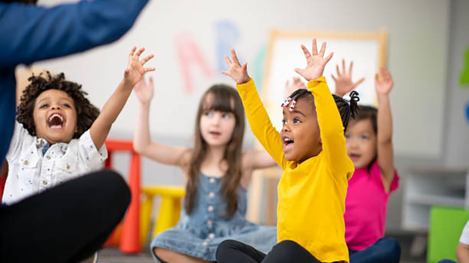 Children, excited with hands in air