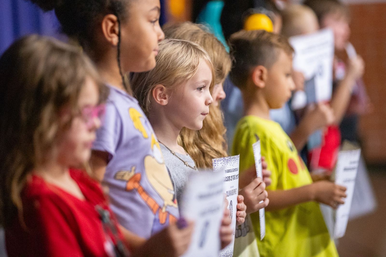 A group of students hold their award certificates.