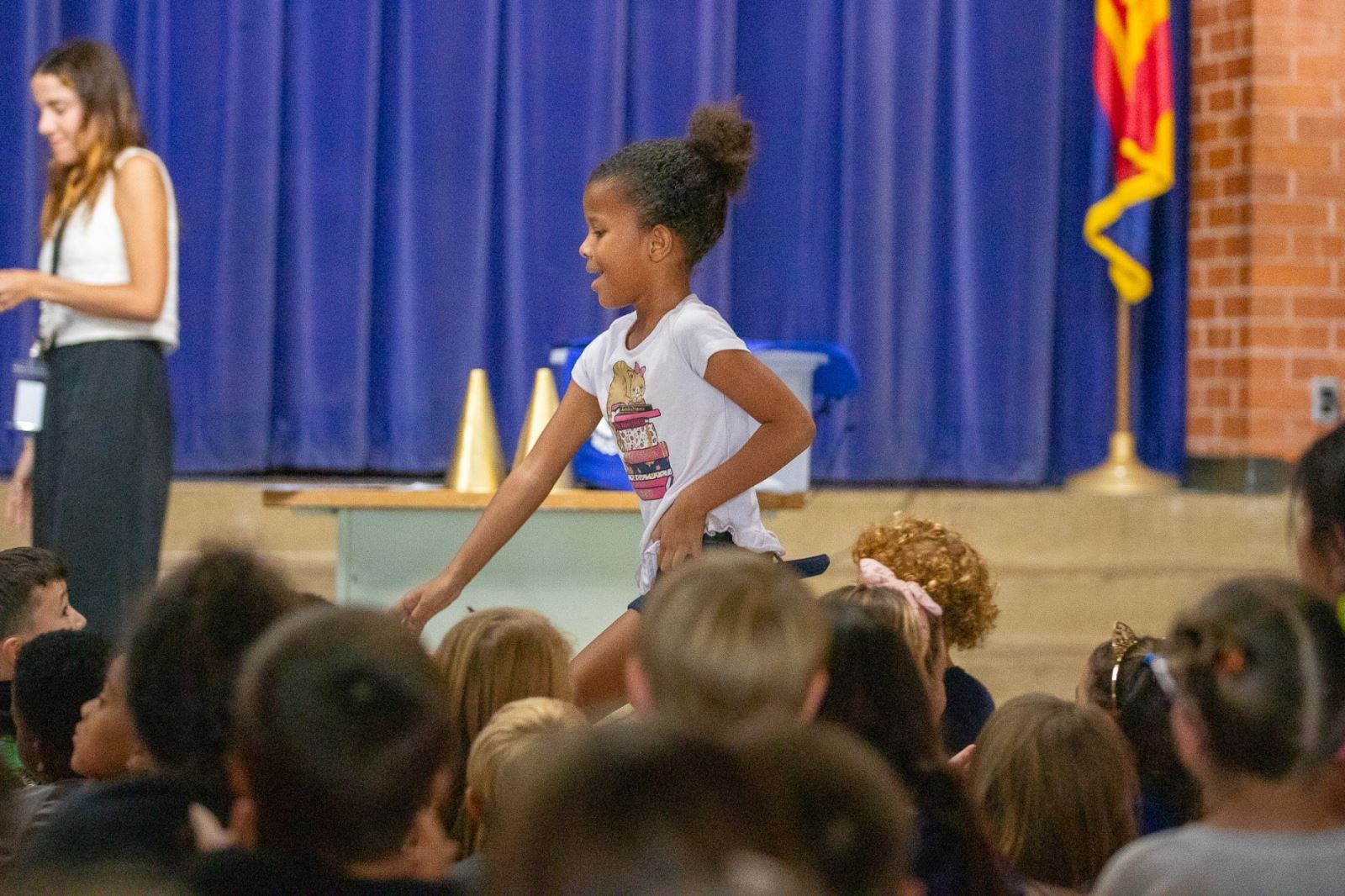 A girl smiles as she heads up to the stage for her award.