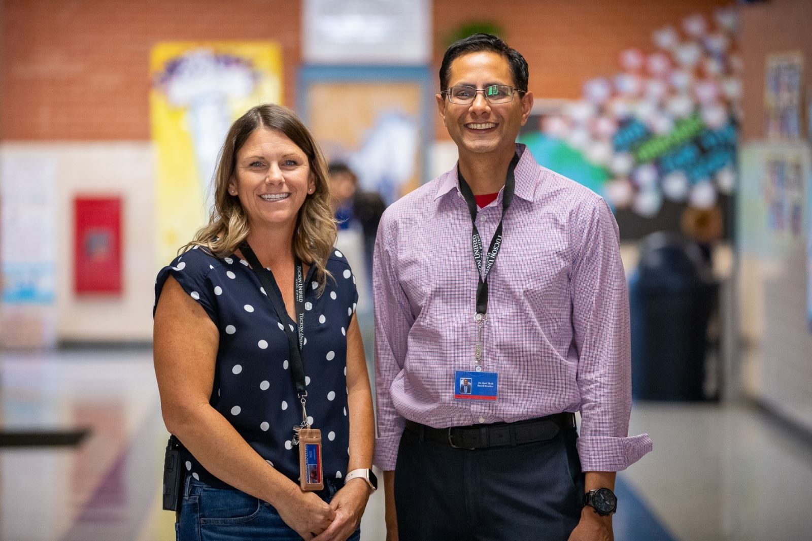 Marshall Principal Emily Seuss and Governing Board President Dr. Ravi Shah smile in the hallway during his visit.