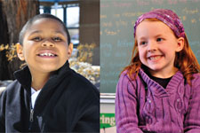 Young boy in a black jacket and young girl in a purple sweater smile. 