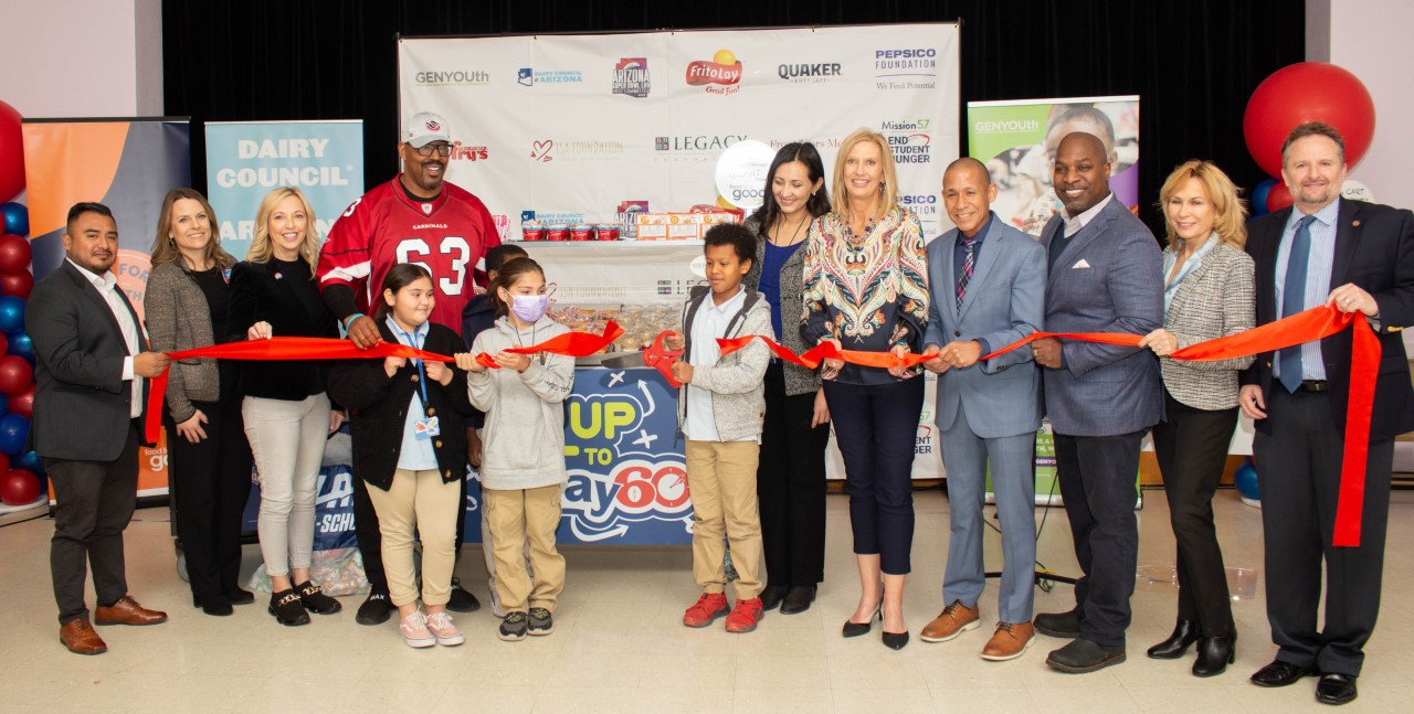 GENYOUth presents school meal kits during a ribbon cutting ceremony at John B. Wright Elementary School.