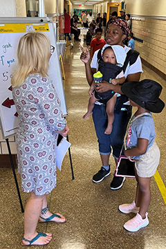 Principal Blair-Long of Robison Elementary greets families as they arrive for the meet and greet before school.