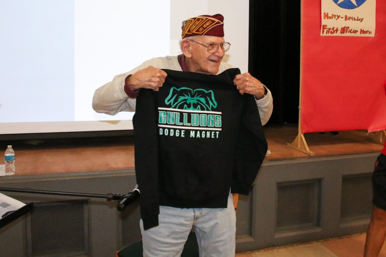 First Officer Harvey Horn holds up his new Dodge Bulldogs shirt.