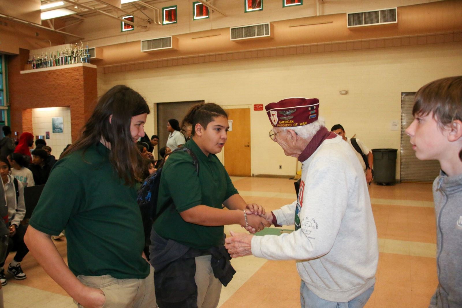 First Officer Harvey Horn shakes a student's hand.