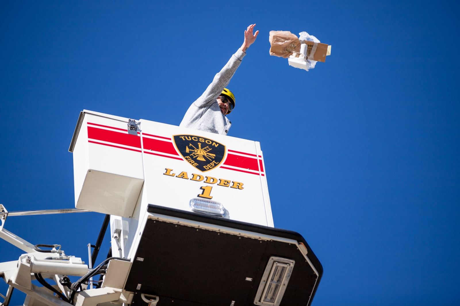 Mr. Taylor drops an egg from a Tucson Fire Department fire truck.