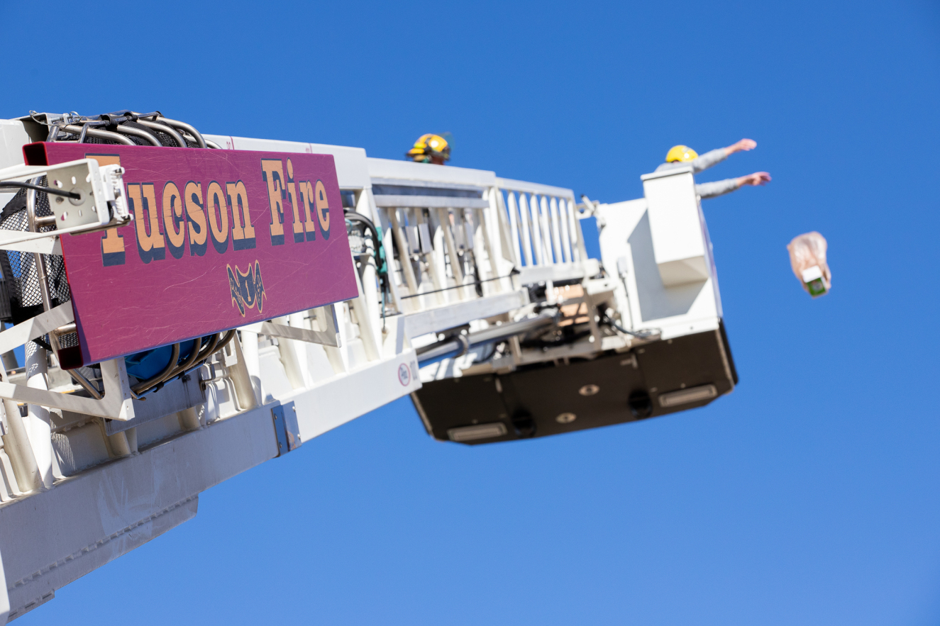 A wide view of Mr. Taylor dropping an egg from a fire truck.